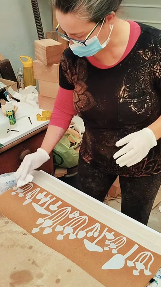 Maryann creating a mushroom stencil design